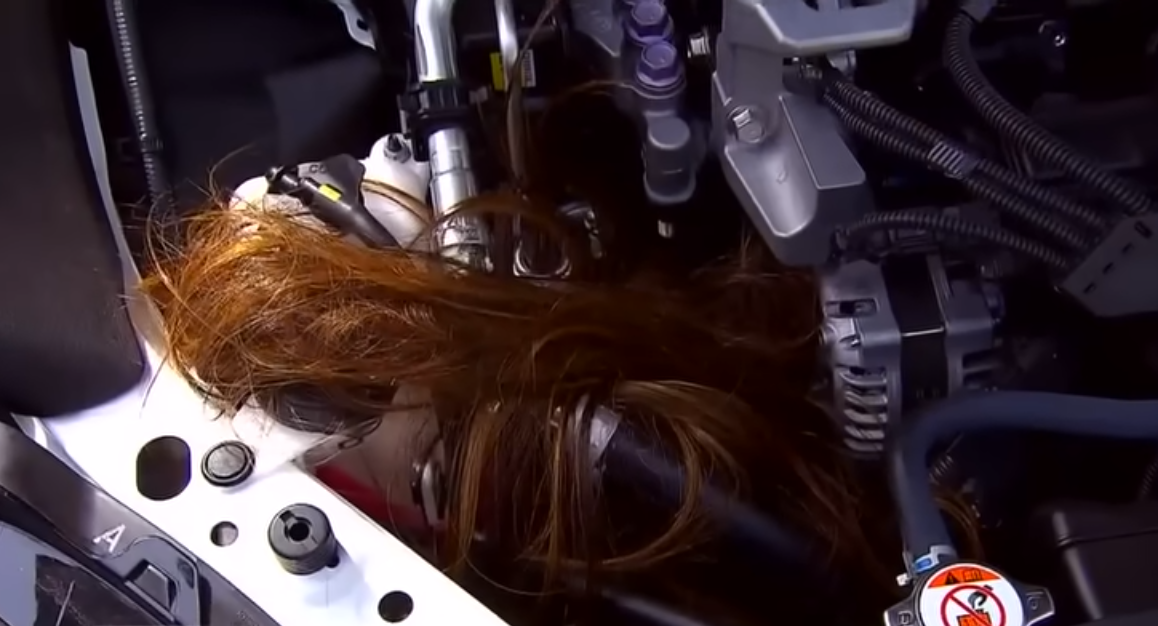 Human hair stuck inside a car engine, Photo Credit: Inside Edition/Youtube