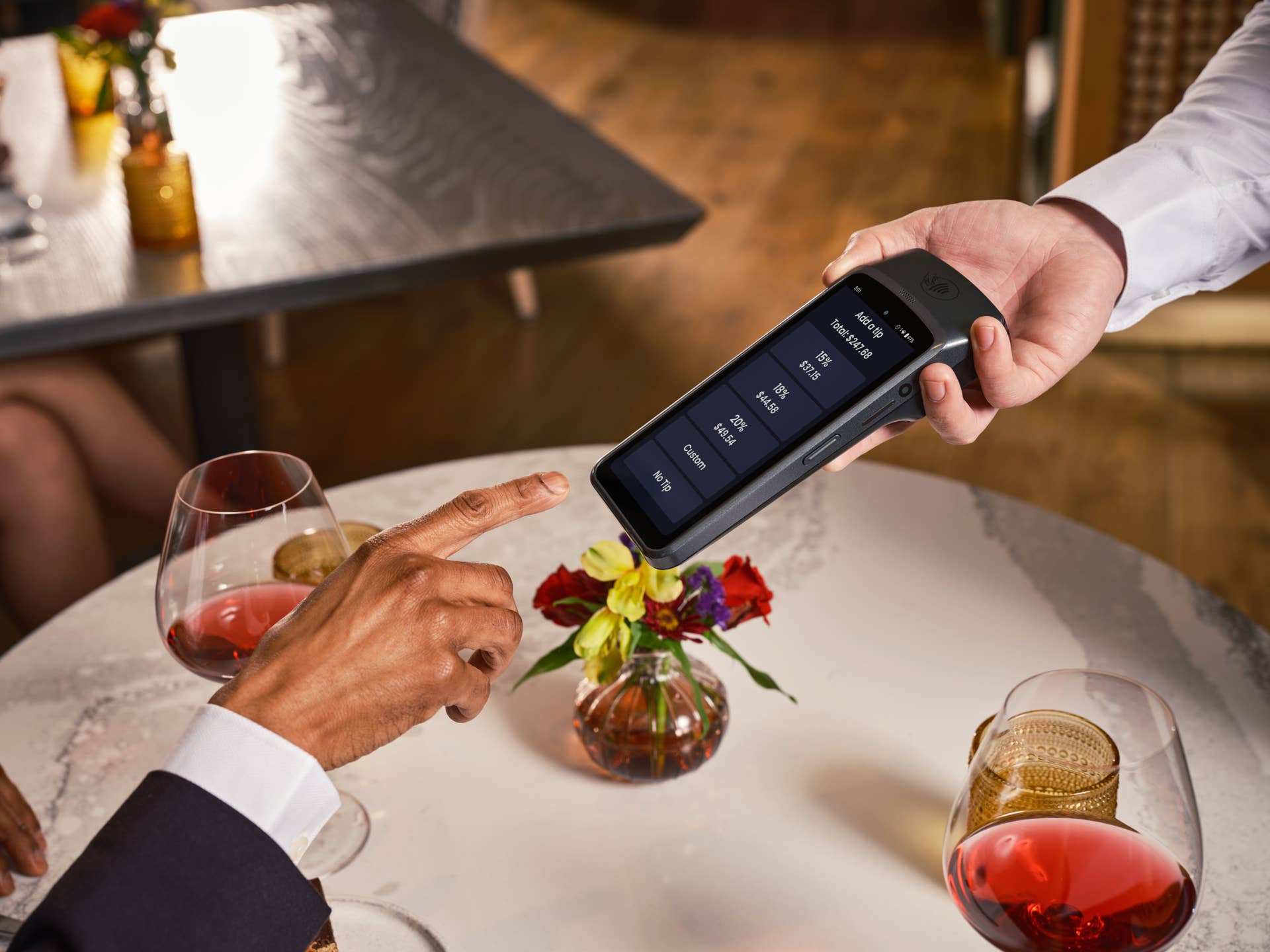 Elegant fine dining setting with a digital point of sale system for seamless payment and tipping, Photo Credit: SpotOn POS/Pexels