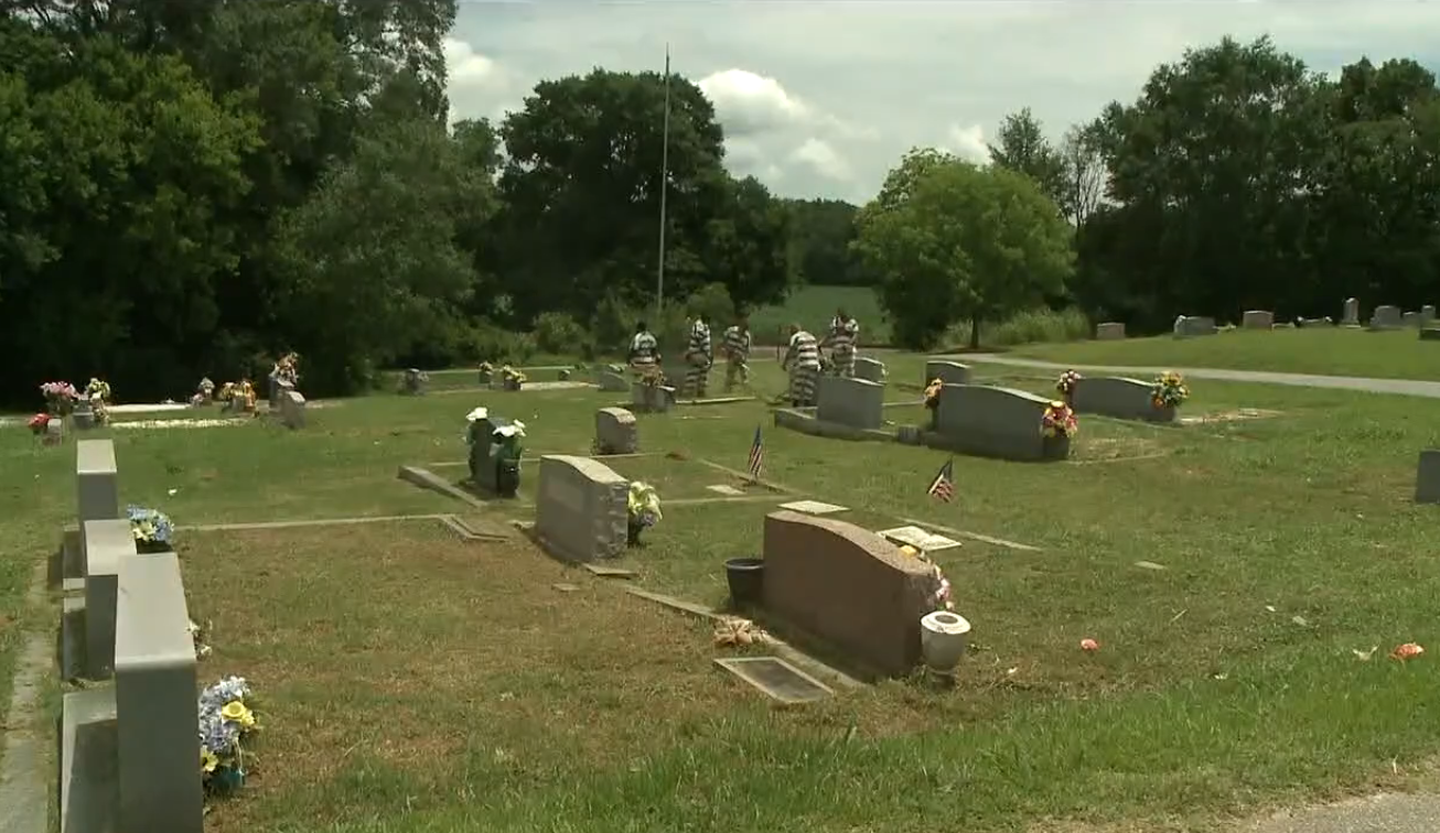 Georgia prison inmates in striped uniforms doing yard work at a cemetery, Photo Credit: 11Alive/Youtube