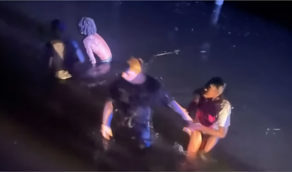 Corion Evans with others rescruing 4 people in the Pascagoula River in Mississippi, Photo Credit: MS Now/Youtube