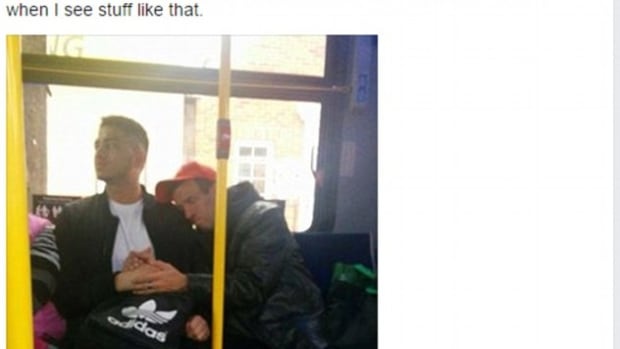 stranger holds special needs man's hand on bus