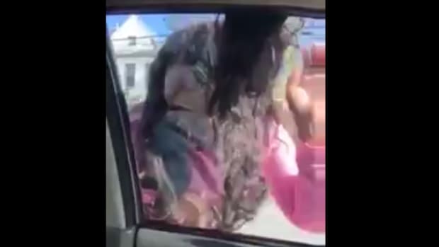 Screenshot, man pulling girlfriend's hair through car window and dragging her down road