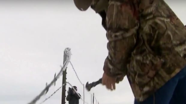Oregon Militia member tearing down fence