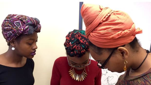 Students wearing geles, African head wraps