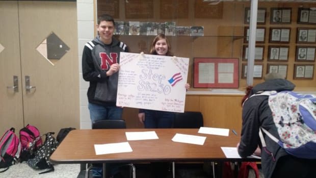 Students at Byron Center High School collect signatures against a bill proposing to lower the minimum wage for people under 20