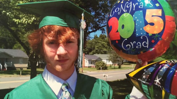 Mason Cox With Graduation Balloons.