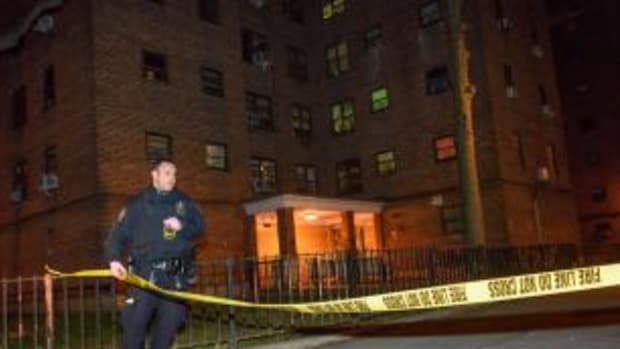 crime scene tape outside apartment building where bodies were found