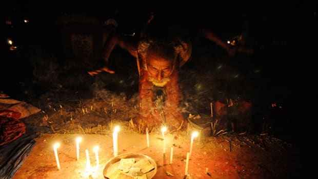 Man performing ritual at a sacrificial altar