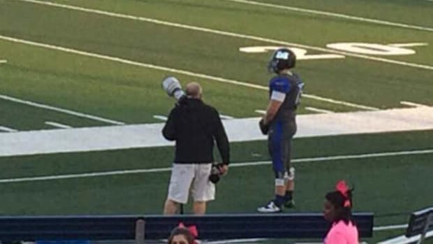 Football Player Stands Alone On Field For Shocking Reason (Photo) Promo Image