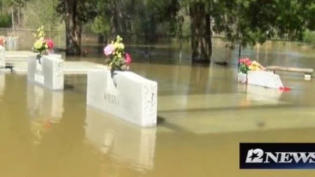 Caskets Float To Surface Amid Deadly Flood Promo Image