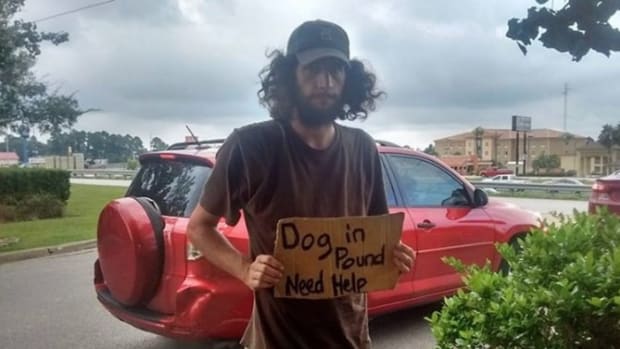 Mom Sees Homeless Man Holding Up Sign In Walmart Lot, Freezes When She Sees What It Says (Photo) Promo Image