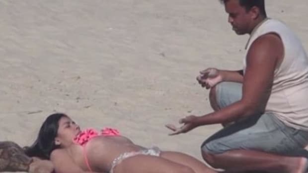 Man Agrees To Put Sunscreen On Beautiful Woman's Back, Gets A Big Surprise (Video) Promo Image