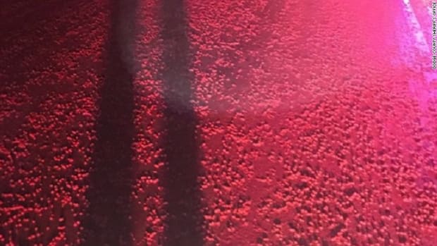 Thousands Of Red Skittles Found Spilled Over Road (Photo) Promo Image