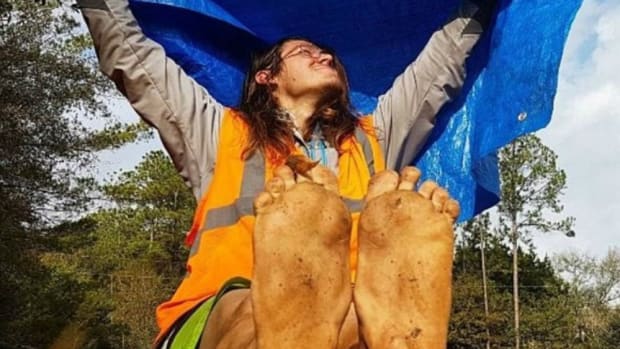 Environmentalist Killed During Barefoot Walk Across US Promo Image