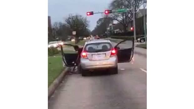 Woman Stops Traffic To Beat Passenger (Video) Promo Image