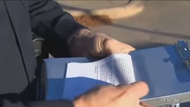 Man Notices Something Rolled Up Inside Traffic Ticket Officer Handed Him (Video) Promo Image