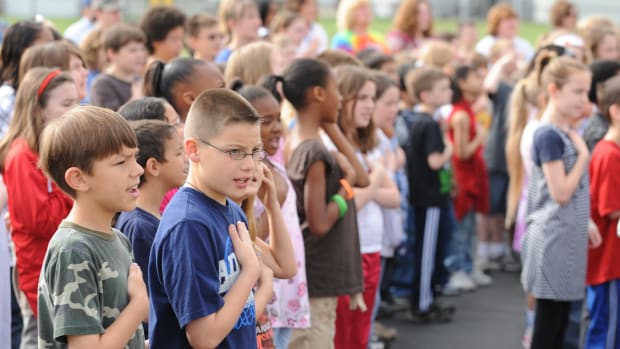 Two Young Boys Face Bullies For Standing During Pledge Promo Image