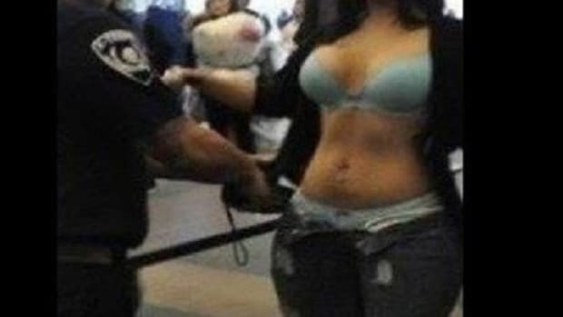 After Noticing Something 'Off' About Woman At Airport, Customs Agents See Her Breasts Promo Image