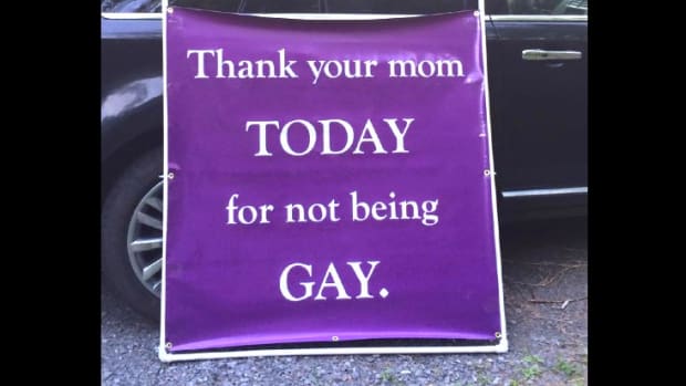 Christian Protester Displays Anti-Gay Mother's Day Sign Promo Image