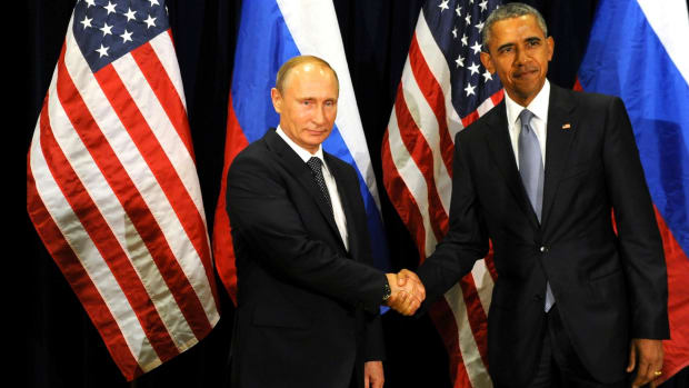 Obama, right, and Putin, left, shake hands in 2015