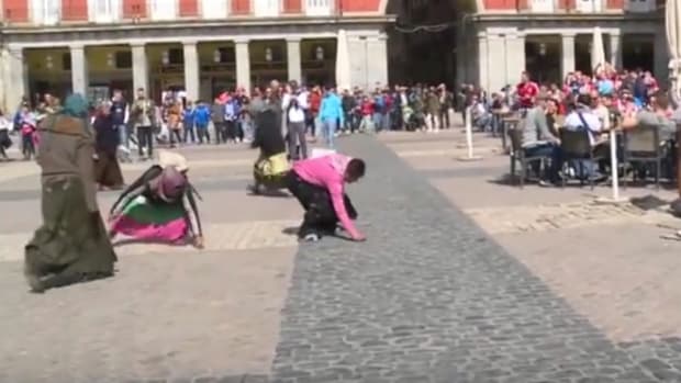 Soccer Fans Throw Coins At Beggars And Laugh (Video) Promo Image
