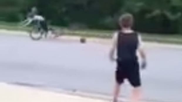Boy Throws Basketball At Girl Riding Bike.