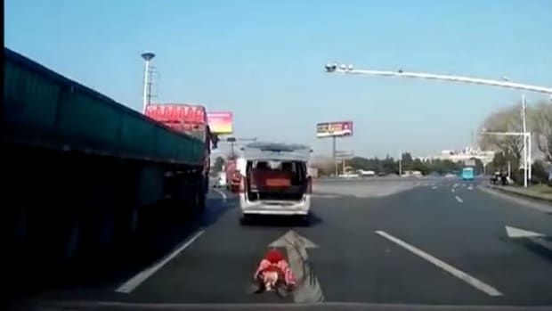 Chinese Toddler Falls Out Of Minivan Onto Highway (Video) Promo Image