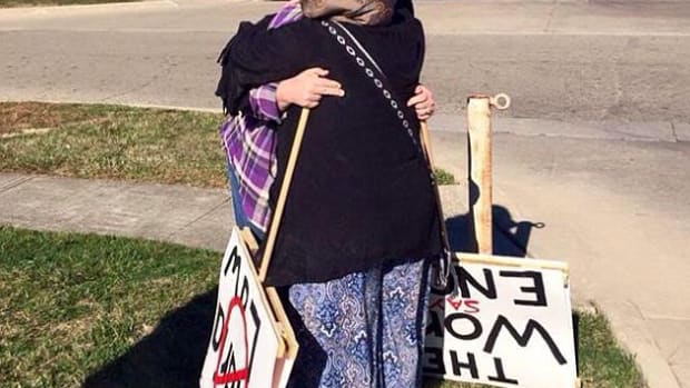 Protester hugs mosque supporter