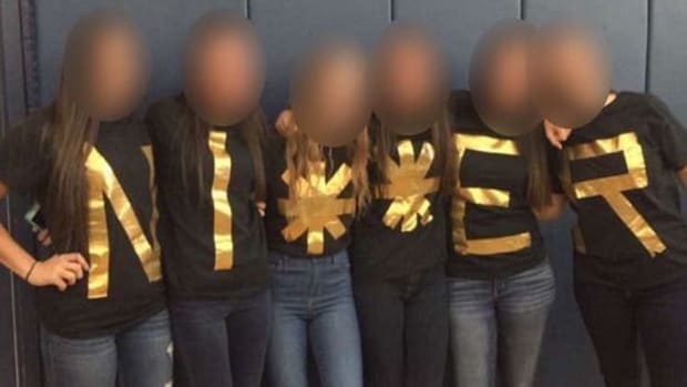 Desert Vista High School seniors wearing T-shirts that, together, spell out NI**ER