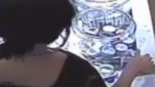 screenshot of security tape showing the suspect poisoning Sofia Santa Cruz's water