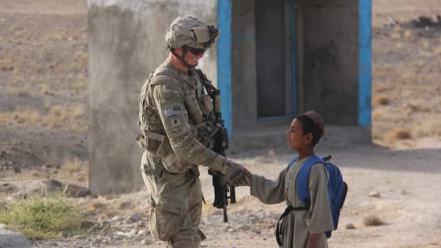 A Soldier And A Boy In Afghanistan.