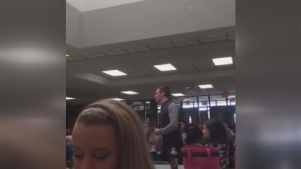 Matthew Clark speaking in the cafeteria 