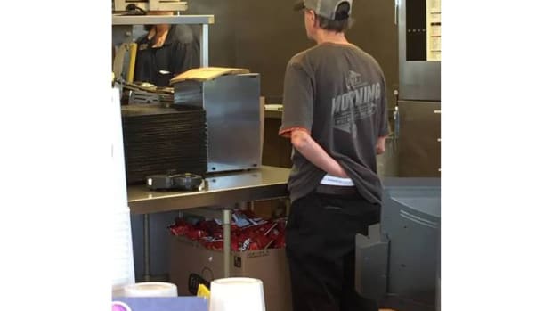 Taco Bell employee with hand down his pants