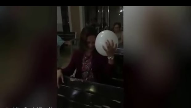 screenshot, white balloon floating towards mother at wake