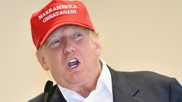 Donald Trump wearing a red "Make America Great Again" hat