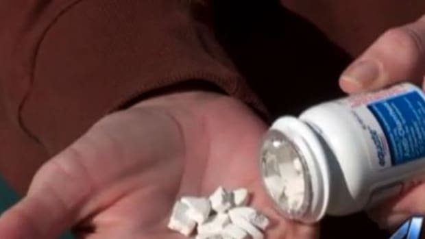Woman Opens Up Bottle Of Pills From Walmart, Makes Upsetting Discovery Promo Image
