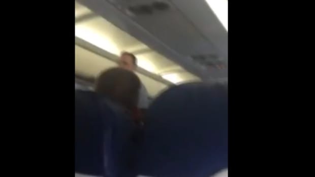 Screenshot, woman being kicked off of american airlines flight