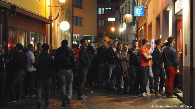 Men wait to get into a nightclub in Germany