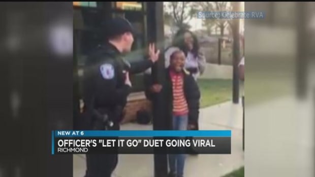 a virginia police officer singing with a local child