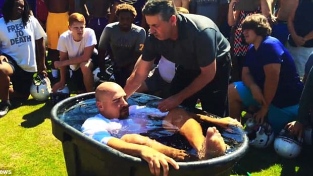 Football players being baptized