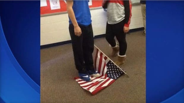 Student Standing On Flag