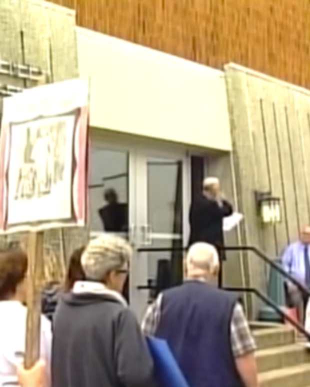 people holding signs at rally in front of Breathitt County Courthouse