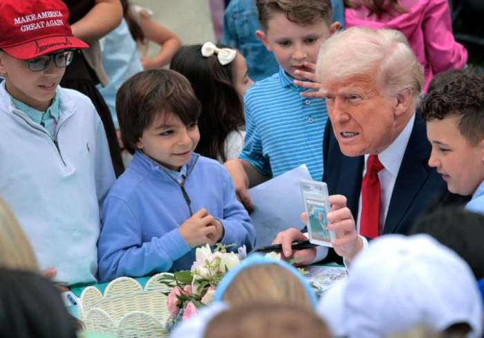 President Donald Trump showing a Trading Card at the 2025 White House Easter Egg Roll, Photo Credit: Moog/X