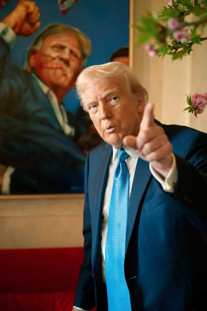 President Donald Trump in an interview with the backdrop of a portrait of him during the assassination attempt, Photo Credit: Sprinter Observer/X