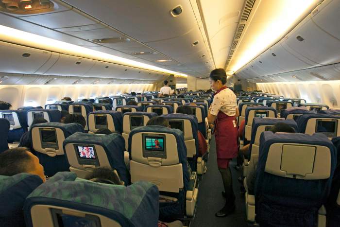Flight Attendant working while in flight, Photo Credit: Pexels