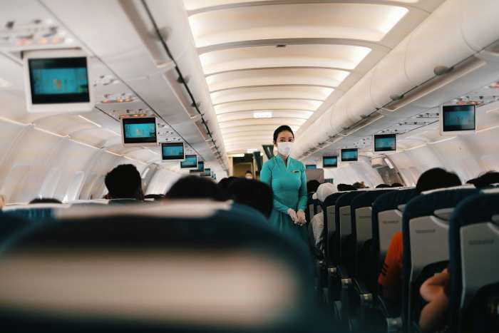 A Flight Attendant Standing in the Cabin, Photo Credit: Pexels