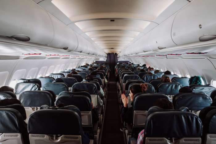 Airplane passengers seated inside a plane, Photo Credit: Pexels