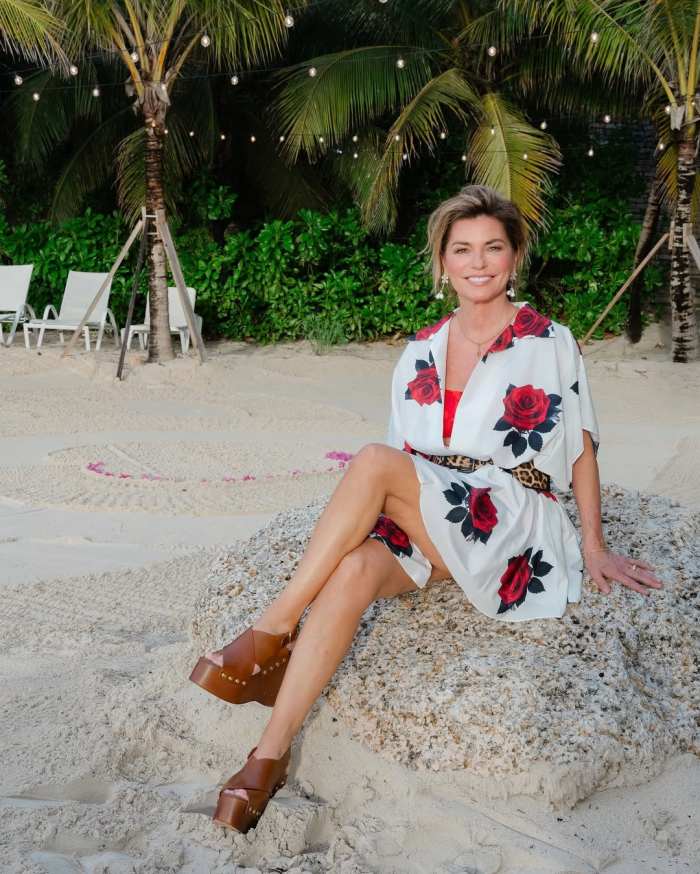 Shania Twain sitting on a rock at the beach, Photo Credit: shaniatwain/Instagram