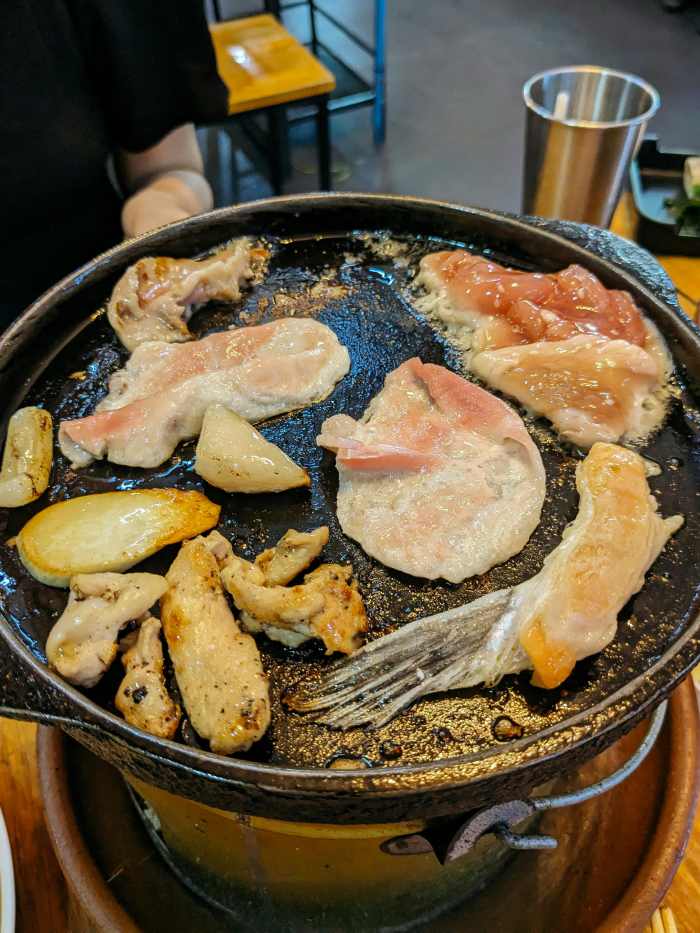 A pan filled with meat and vegetables on a stove, Photo Credit: Pexels