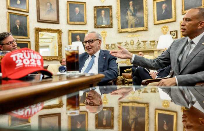A Trump 2028 hat on the desk with House Speaker Mike Johnson, Senate Minority Leader Chuck Schumer and House Minority Leader Hakeem Jeffries, Photo Credit: Politics & Poll Tracker/X